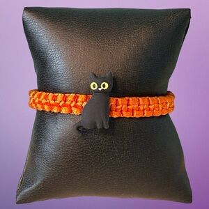 Black cat, yellow eyes on orange, Halloween bracelet, adjustable; smaller